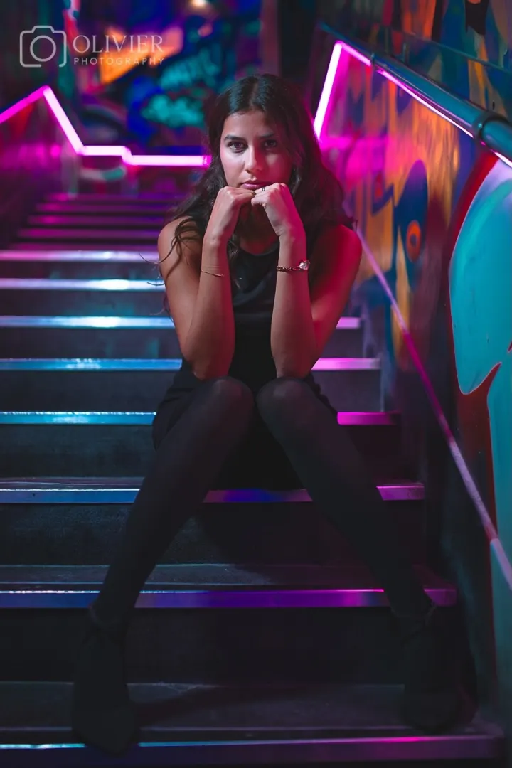 Fashion portrait on a neon-lit staircase in London
