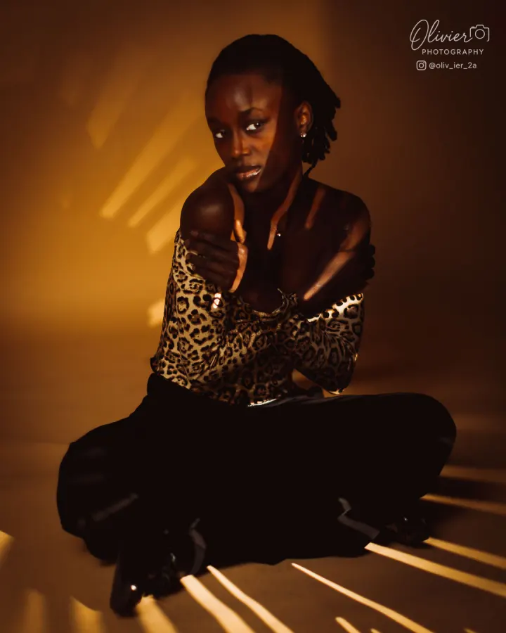 Editorial model portrait in leopard styling and dramatic golden light