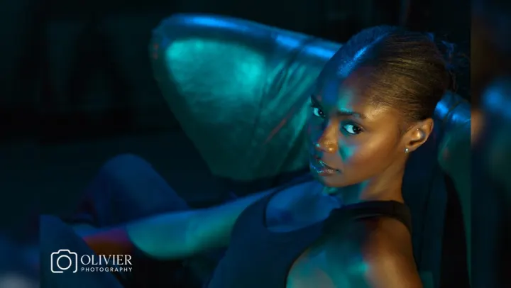 Cinematic close portrait illuminated with teal and amber light