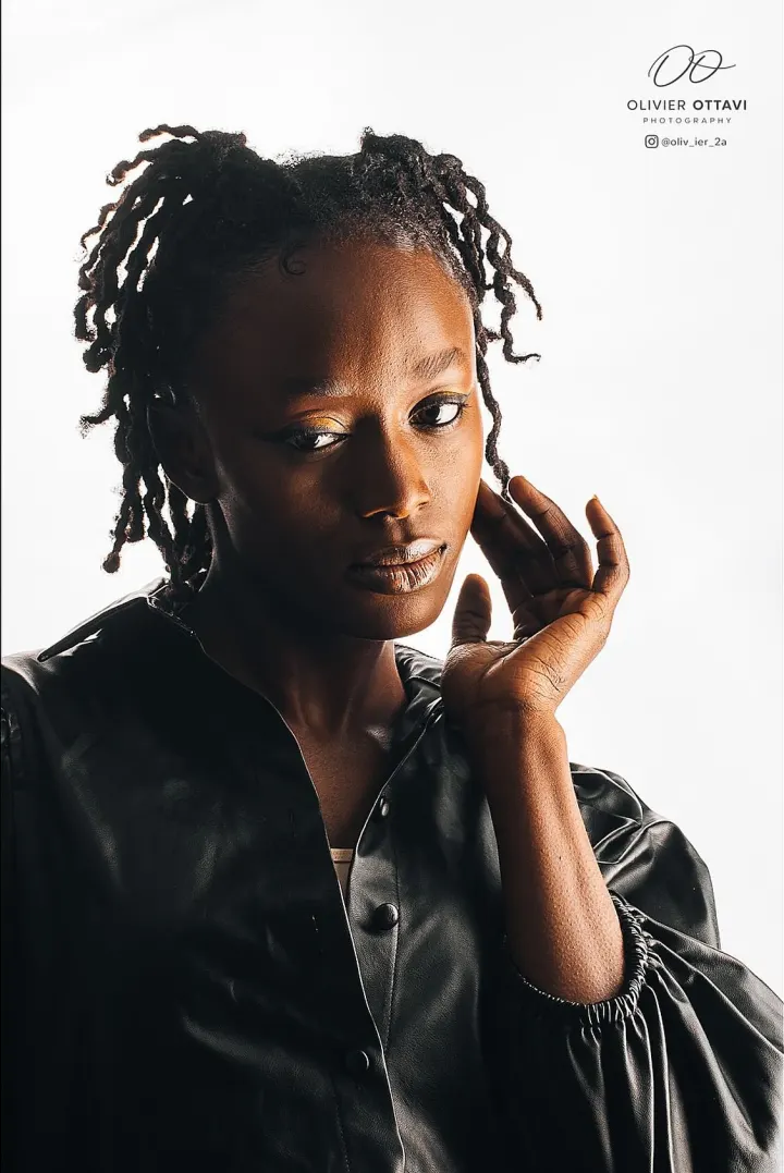 Sculptural fashion portrait in black leather against a luminous white background