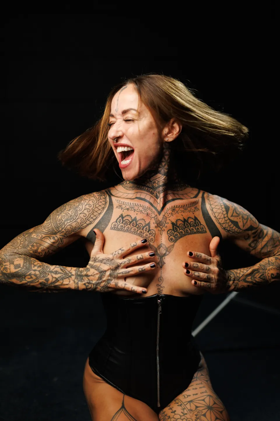Expressive tattooed model in an editorial studio portrait